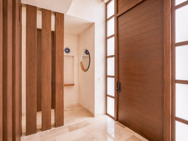 Vestíbulo con paneles de madera ranurada en Casa Maru
